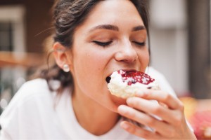 A woman enjoying a donut